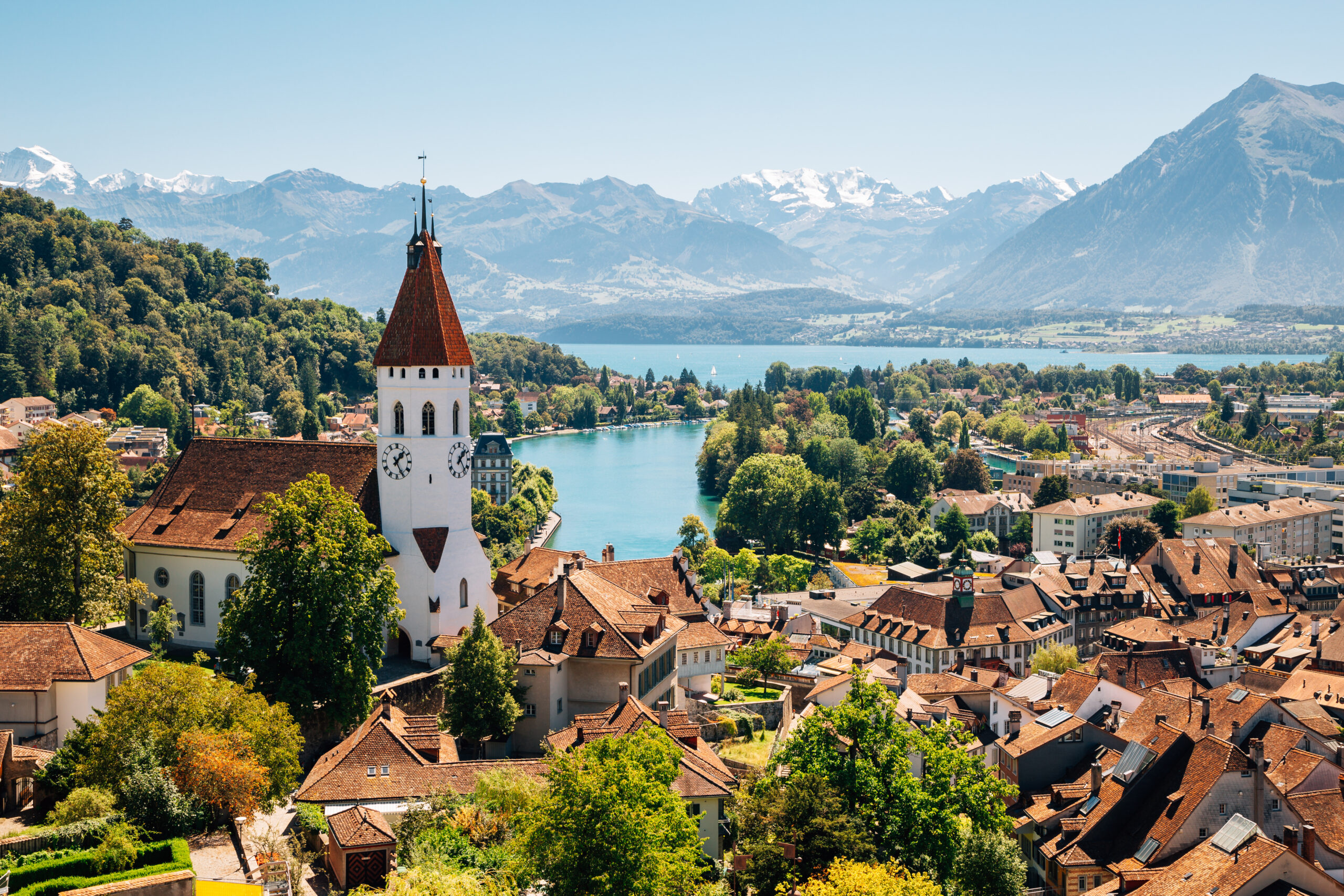 swiss-fixer-swixer-local-production-services-in-switzerland-cityscape-with-alps-and-lake